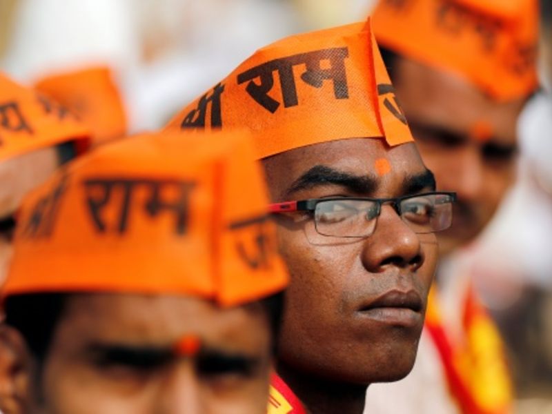 A group of men wearing saffron cap.