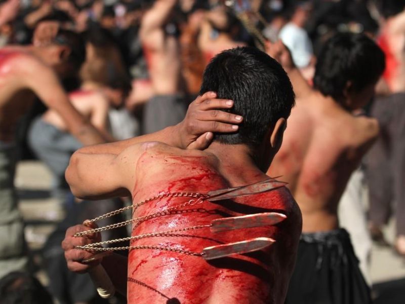 The festival of Muharram - Man hits himself as part of the ritual.